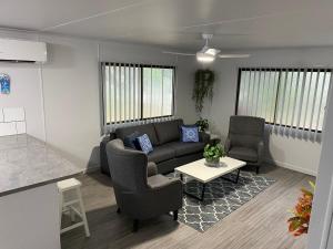 a living room with a couch and chairs and a table at Seaside Breezes with Wi-fi in Slade Point