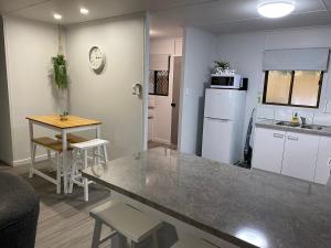 a kitchen with a counter and a table in a room at Seaside Breezes with Wi-fi in Slade Point +26 photos