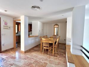 a kitchen and dining room with a table and chairs at Luna-Villa de Riviera with Sea-View in Mijas Costa