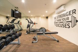 a gym with several exercise bikes and a television at Bayfront Hotel Cebu Capitol Site in Cebu City