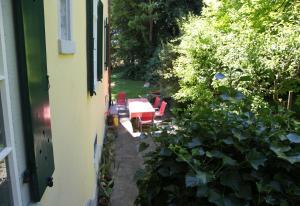 an outside view of a patio with a table and chairs at BnB villaSteiner in Birrwil +1 photo