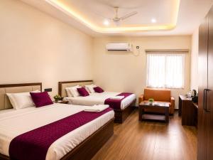a hotel room with two beds and a window at Hotel Lavish Grand in Tenāli +21 photos