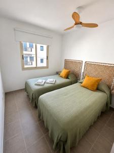 two beds sitting next to each other in a room at El HierroStay Appartments - La Chalana & El Remo in La Restinga