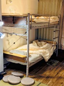 a couple of bunk beds in a room at Maison Stay Kobe in Kobe