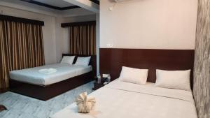 a hotel room with two beds in a room at Sunset Bay Hotel in Cox's Bazar +48 photos