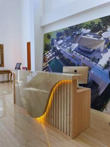 a reception desk with a picture of a resort at Oasis Manzanillo Del Mar in Manzanillo del Mar