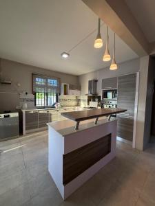 a large kitchen with a island in the middle at Vanz Villa in Mont Choisy