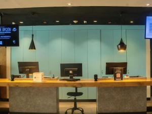 a counter with three computer monitors on top of it at Ibis Mexico Alameda in Mexico City