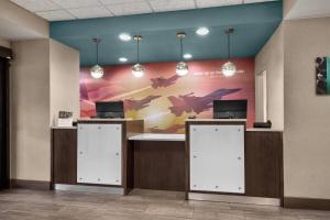 a lobby with a wall with a picture of planes at La Quinta by Wyndham Midwest City - Tinker AFB in Midwest City +42 photos