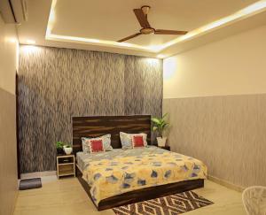 a bedroom with a bed and a ceiling fan at Royal Orchid in Faridabad
