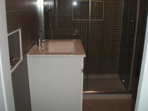 a bathroom with a sink and a shower at Charming Apartment in Troia, Garden View, 60 sqm in Troia