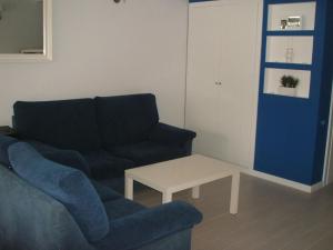 a living room with a couch and a coffee table at Charming Apartment in Troia, Garden View, 60 sqm in Troia