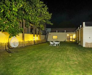 a yard with chairs and a building at night at Royal Orchid in Faridabad