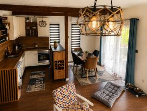 a kitchen and living room with a table and chairs at Holiday Home Alen - Una National Park Retreat - with Garden & Terrace in Kulen Vakuf