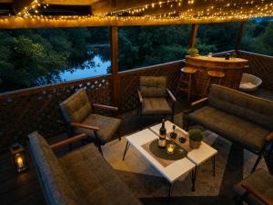 a deck with chairs and a table and lights at Holiday Home Alen - Una National Park Retreat - with Garden & Terrace in Kulen Vakuf +9 photos