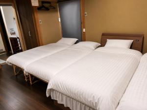a group of four beds in a room at 結良house in Yura +26 photos