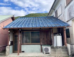 a house with a window and a roof at Aoi-Yane Traditional Japanese House in Kumano Kodo Nakahechi in Tanabe