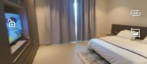 a hotel room with a bed and a tv at Résidences Aya in Abidjan