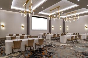 a conference room with tables and chairs and a projection screen at Doubletree By Hilton Midland West Loop I-250 in Midland +52 photos