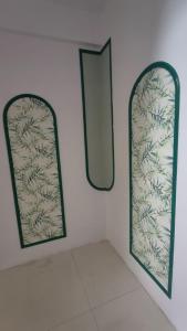 a bathroom with two mirrors on the wall at LuxeBnb - Hill View 2bhk Baner in Pune