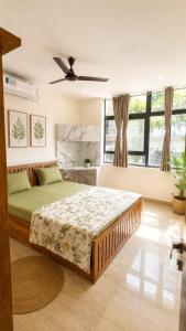a bedroom with a bed and a ceiling fan at LuxeBnb - Hill View 2bhk Baner in Pune