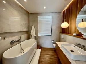 a bathroom with a large tub and a sink at Breathtaking seaview penthouse - Belle Mare in Post of Flacq +35 photos