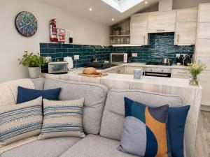 a living room with a couch and a kitchen at Seaside Escape in Westward Ho! 3-Bed Family Holiday Home with Sea Views in Westward Ho