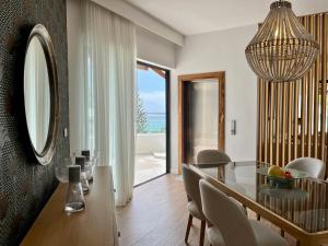 a dining room with a table and a mirror at Breathtaking seaview penthouse - Belle Mare in Post of Flacq