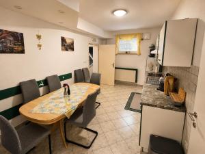 a kitchen and dining room with a table and chairs at Apartment CDR in Zreče +1 photo