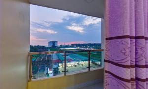 a room with a window with a view of a stadium at Hotel Sea Cox in Cox's Bazar