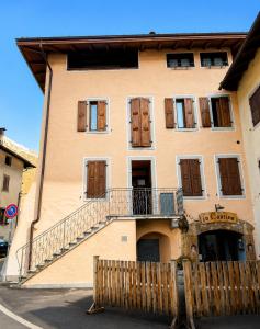 a building with a staircase on the side of it at Dolomiti House in Pinzolo