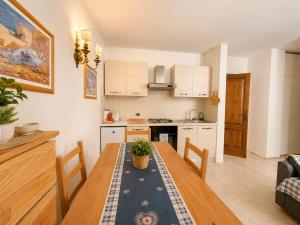 a kitchen and dining room with a wooden table at Dolomiti House in Pinzolo