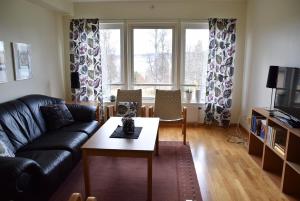 a living room with a couch and a coffee table at Mullsjö Folkhögskola in Mullsjö