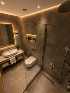 a bathroom with a shower and a toilet and a sink at Cher Hotel Eyüp in Istanbul +30 photos