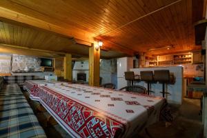 a room with a bed with a red and white blanket at Вила Рай in Elena
