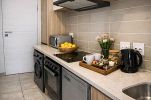 a kitchen counter with a bowl of fruit and a sink at The Blyde Spot in Pretoria