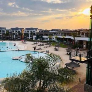 a large swimming pool with people in a resort at The Blyde Spot in Pretoria