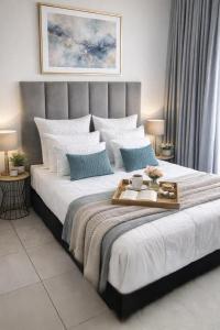 a bedroom with a large bed with a tray on it at The Blyde Spot in Pretoria