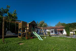 a playground in a yard with a slide at Вила Рай in Elena