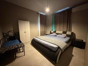a bedroom with a large bed and a chair at Vanz Villa in Mont Choisy +23 photos