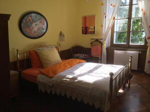 a bedroom with a bed and a chair and a window at BnB villaSteiner in Birrwil
