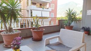 a balcony with a chair and potted plants on it at dolce dimora in Pagani