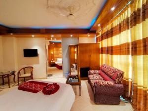 a hotel room with a bed and a couch at Praasad Paradise in Cox's Bazar +69 photos