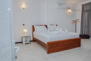 a bedroom with a bed with two white pillows at Aranya Heights Luxury 7 Pax Home in Wattala