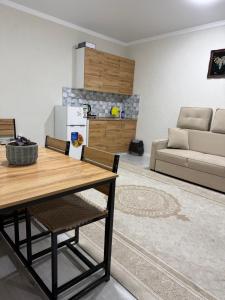 a kitchen and living room with a table and a couch at Гостевой дом Бакай in Imeni Kirova