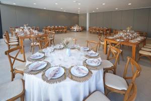 a banquet hall with tables and chairs with plates and napkins at Holiday Inn Navojoa by IHG in Navojoa +122 photos