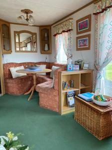 a living room with a couch and a table at Craigmore Caravan in Coleraine