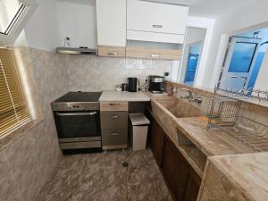 a kitchen with a stove and a counter top at Studio Garden City Center Pomorie in Pomorie