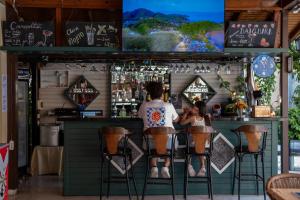 two people sitting at a bar at Miray Hotel Kleopatra in Alanya