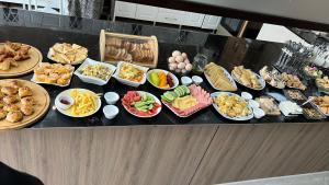 a buffet with many plates of food on a table at Comfort Hotel in Osh